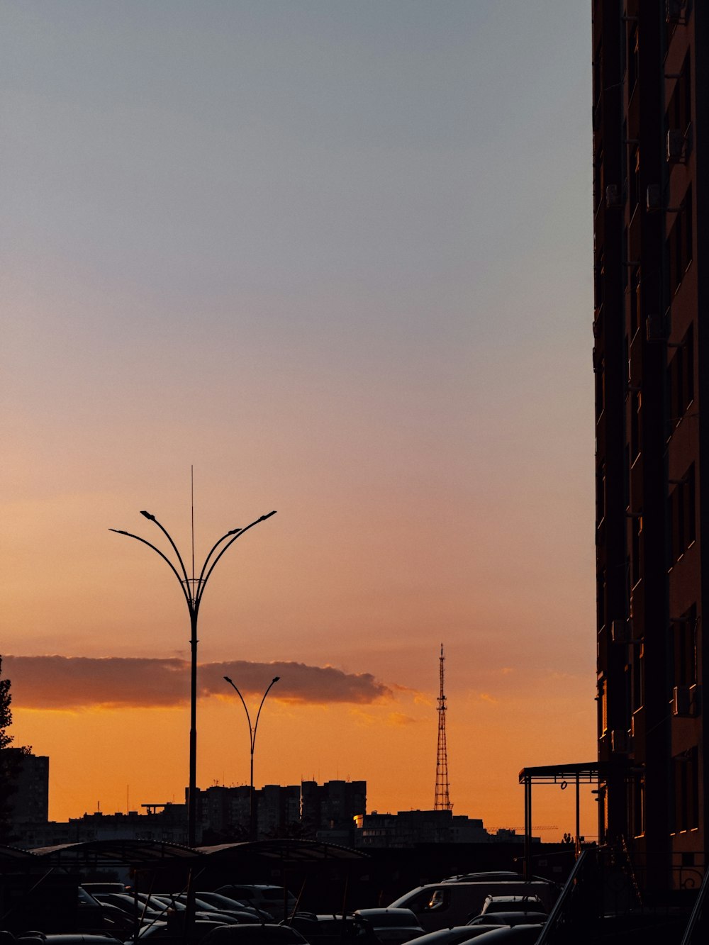 the sun is setting over a city with tall buildings