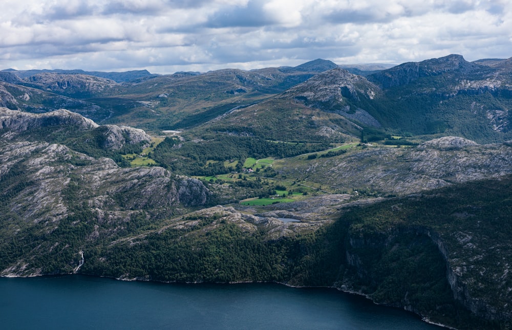 an aerial view of a lake surrounded by mountains