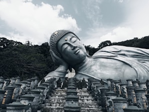 a large buddha statue sitting in front of many smaller ones