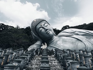 a large buddha statue sitting in front of many smaller ones