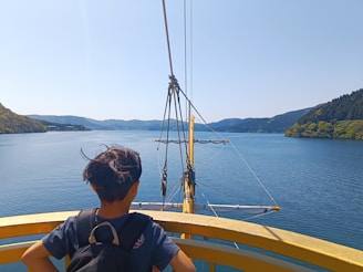 a person sitting on a boat looking out at the water