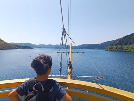 a person sitting on a boat looking out at the water
