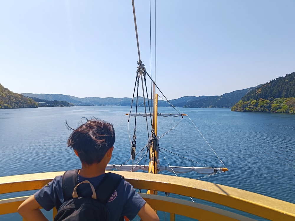 a person sitting on a boat looking out at the water