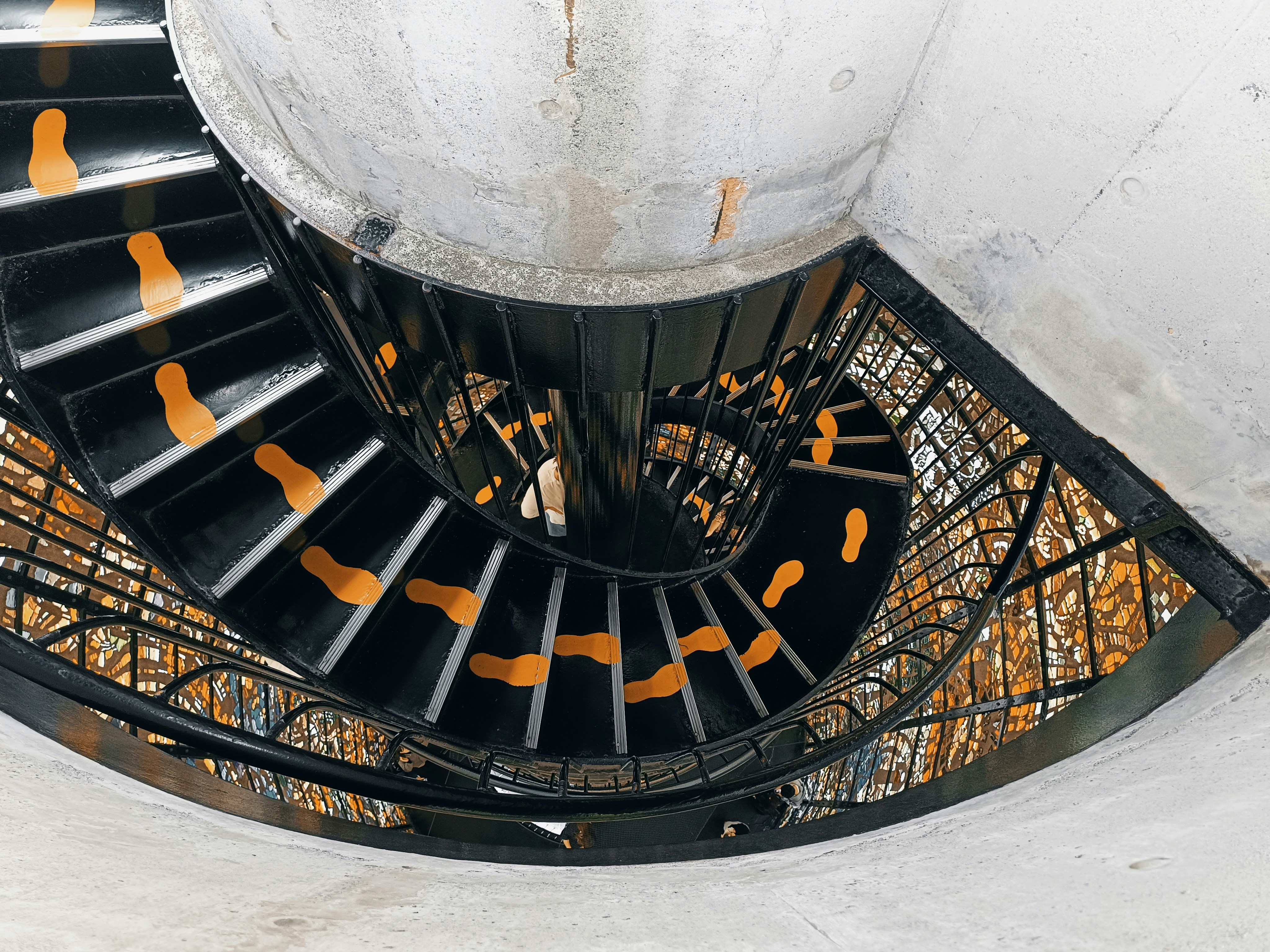 a spiral staircase in a building with orange steps, 