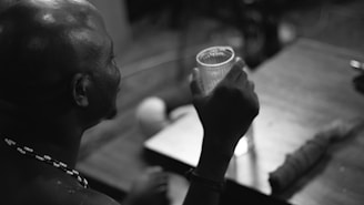 a man holding a cup of coffee up to his face