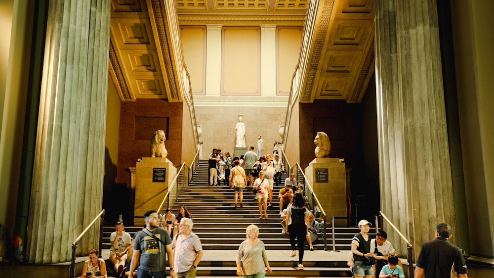 a group of people walking up and down a set of stairs