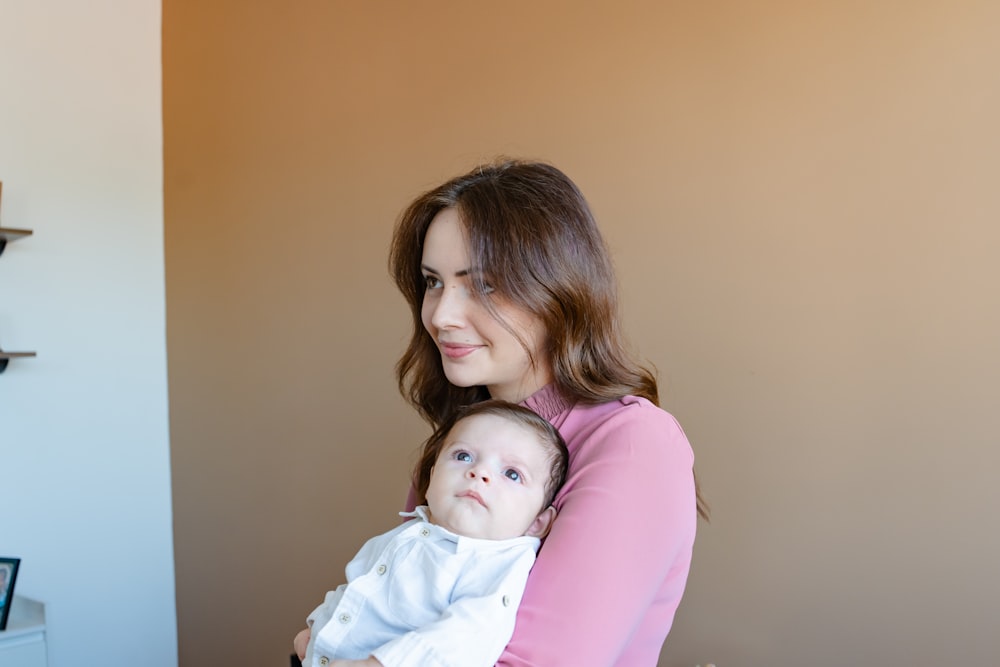 a woman holding a baby in her arms