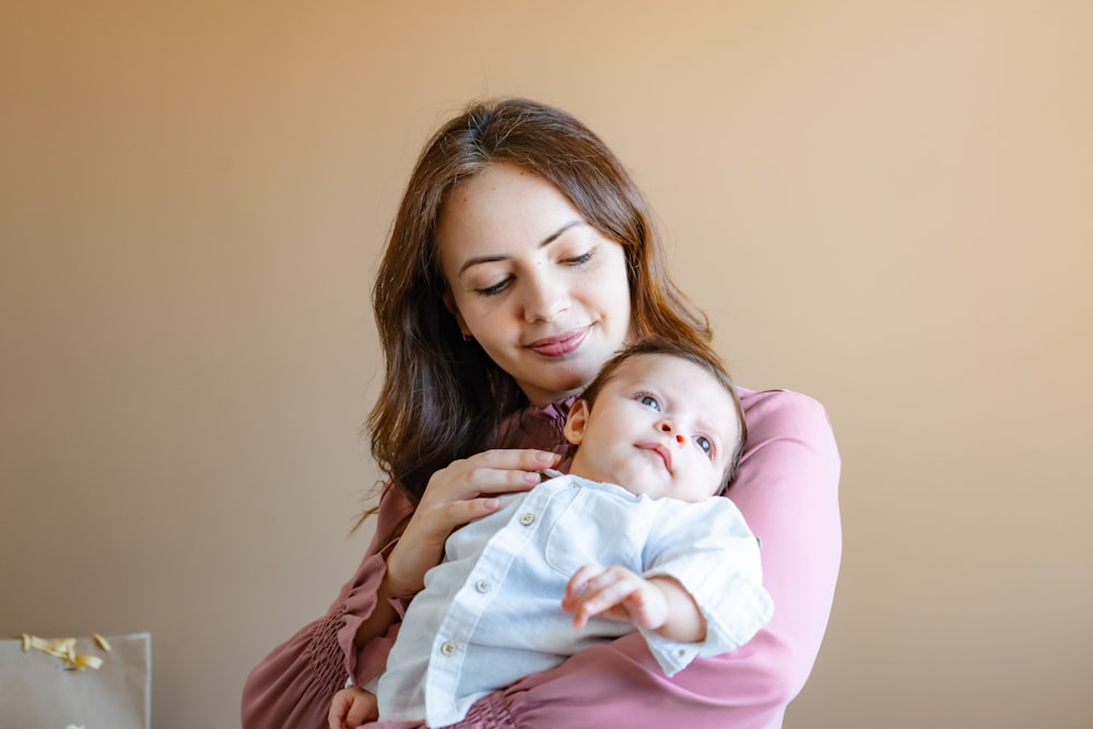 a woman holding a baby in her arms