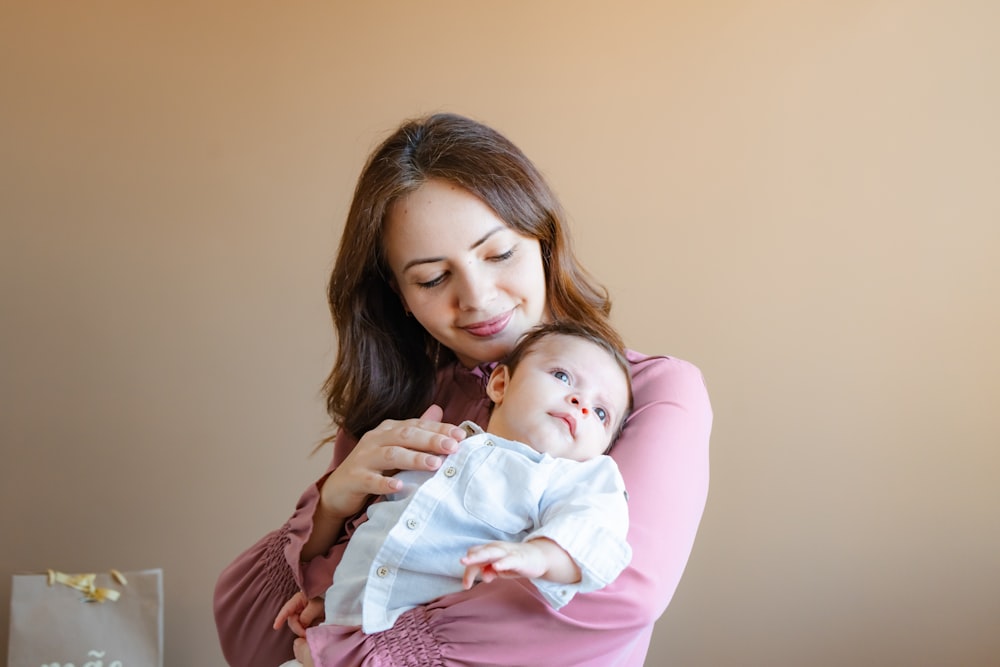 a woman holding a baby in her arms