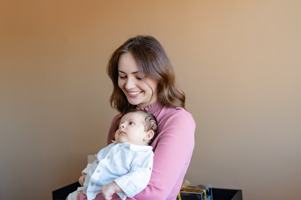 a woman holding a baby in her arms