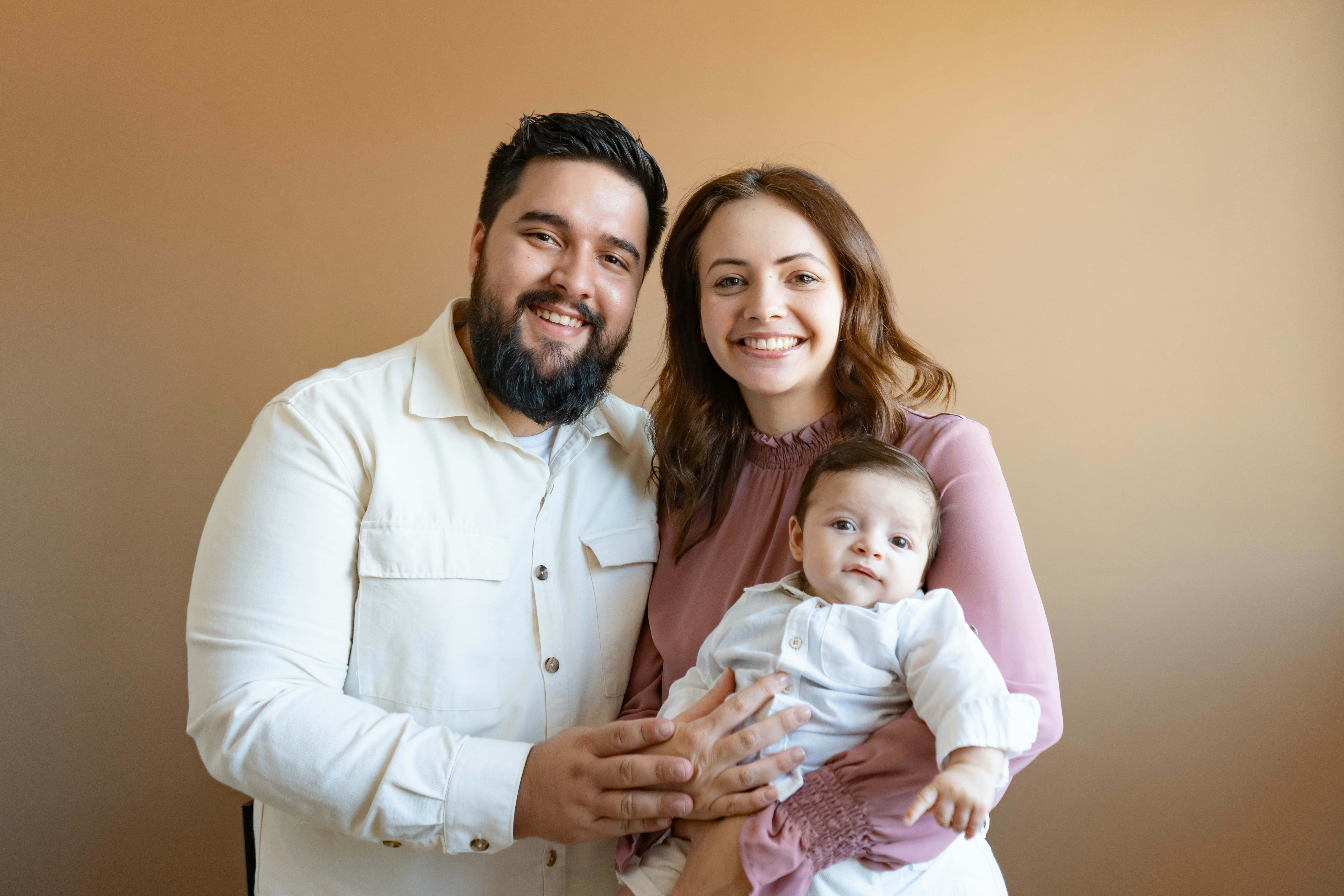 a man and a woman holding a baby
