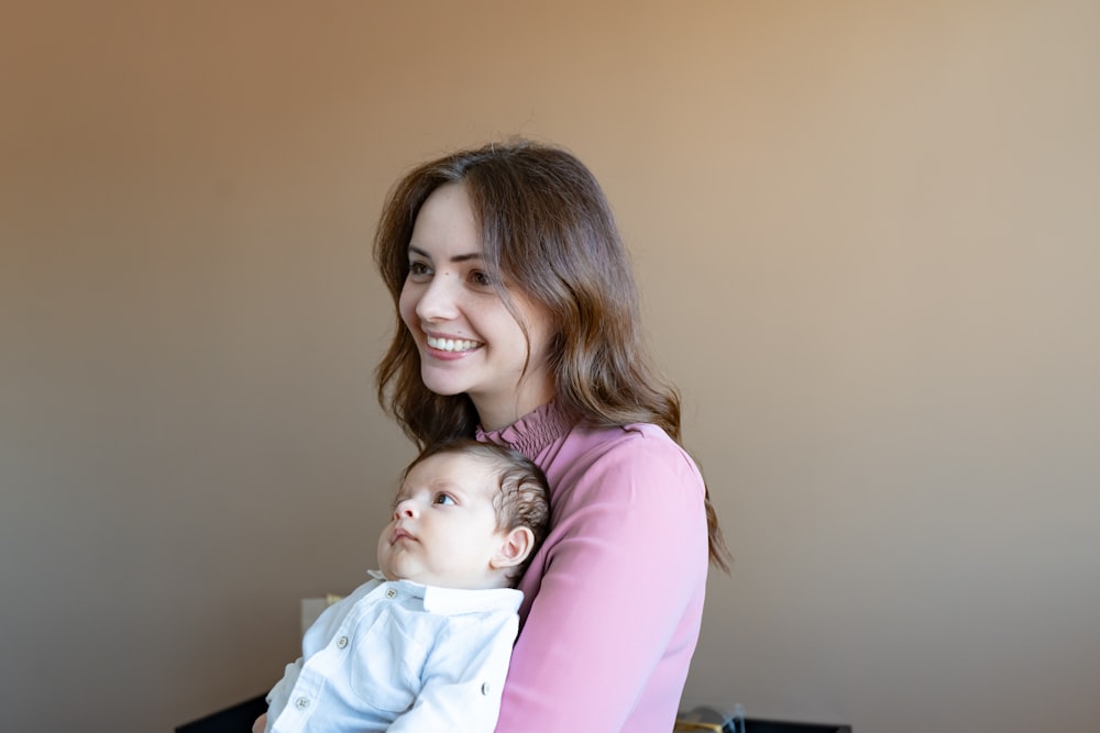 a woman holding a baby in her arms