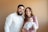 a man and woman pose for a picture with a baby