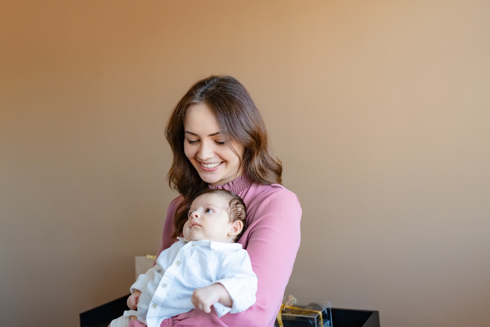 a woman holding a baby in her arms