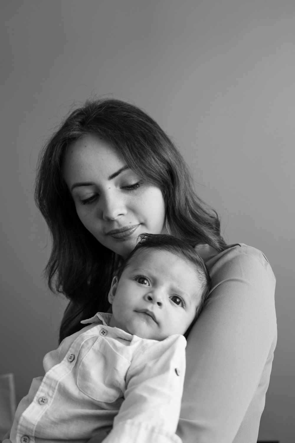 a woman holding a baby in her arms