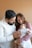 a man and woman holding a baby in their arms