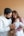 a man and woman holding a baby in their arms