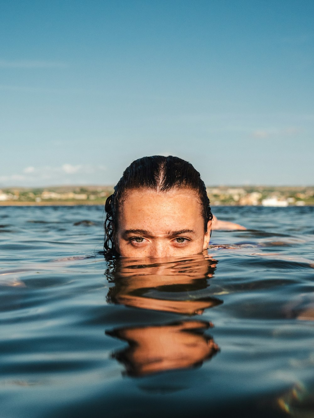 a woman swimming in a body of water