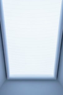 a room with a skylight and a bed in it