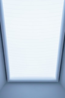 a room with a skylight and a bed in it