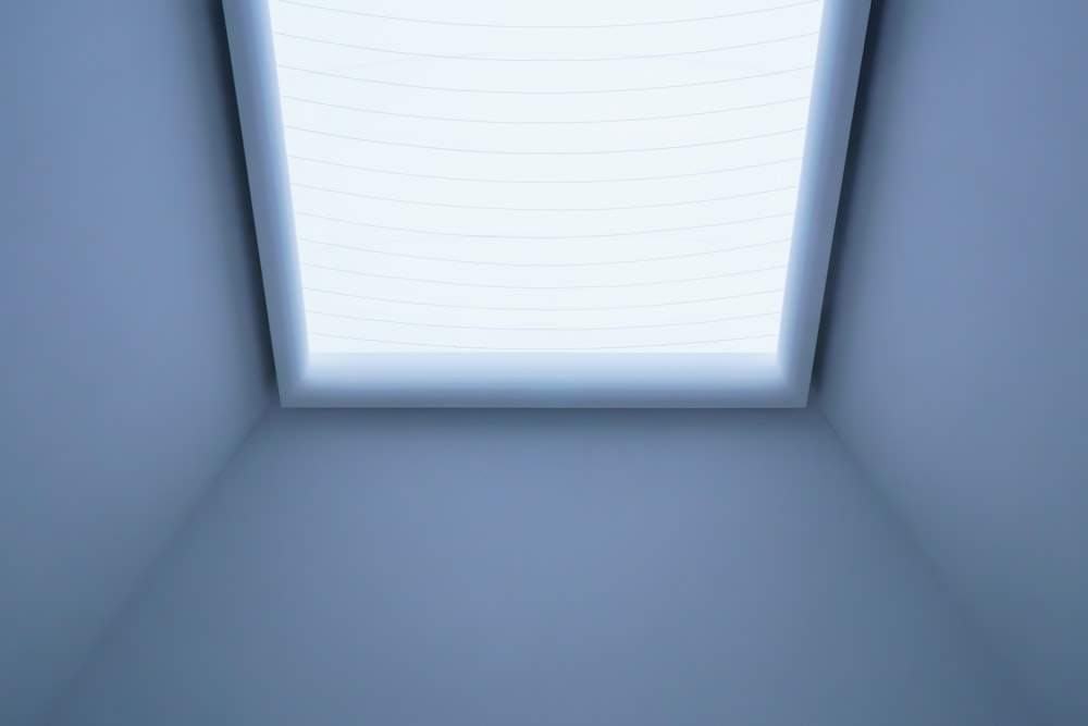an empty room with a white ceiling and a white sheet of paper on the ceiling