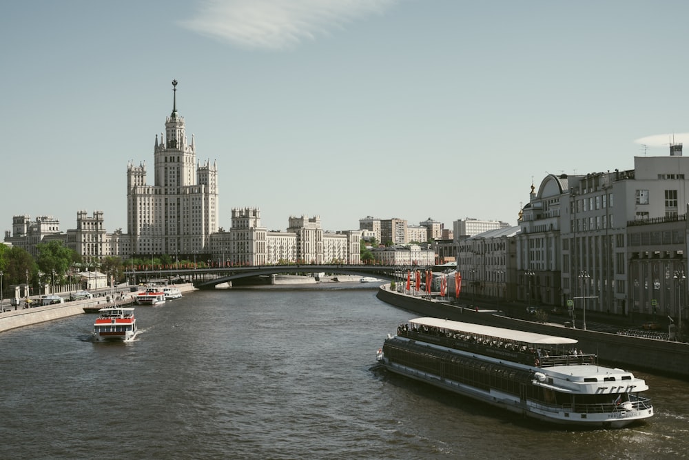 a boat traveling down a river next to tall buildings