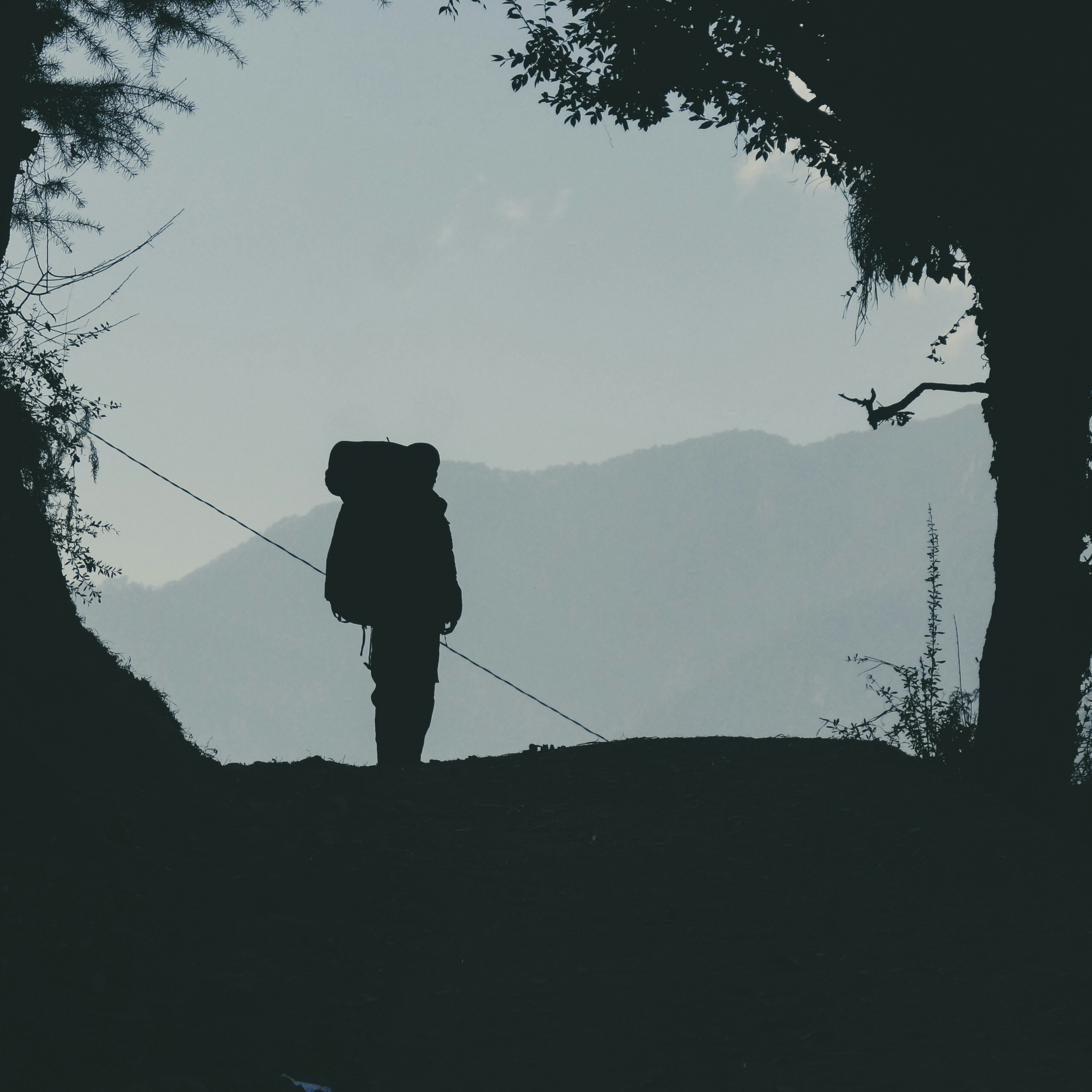 a person with a backpack walking up a hill