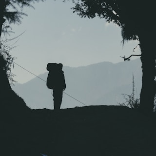 a person with a backpack walking up a hill