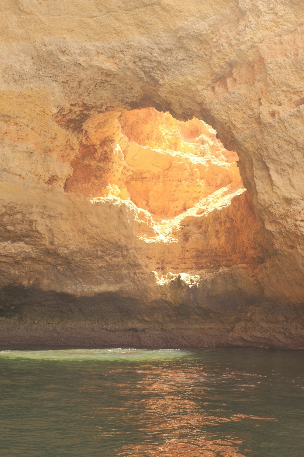 a view of a cave from the water