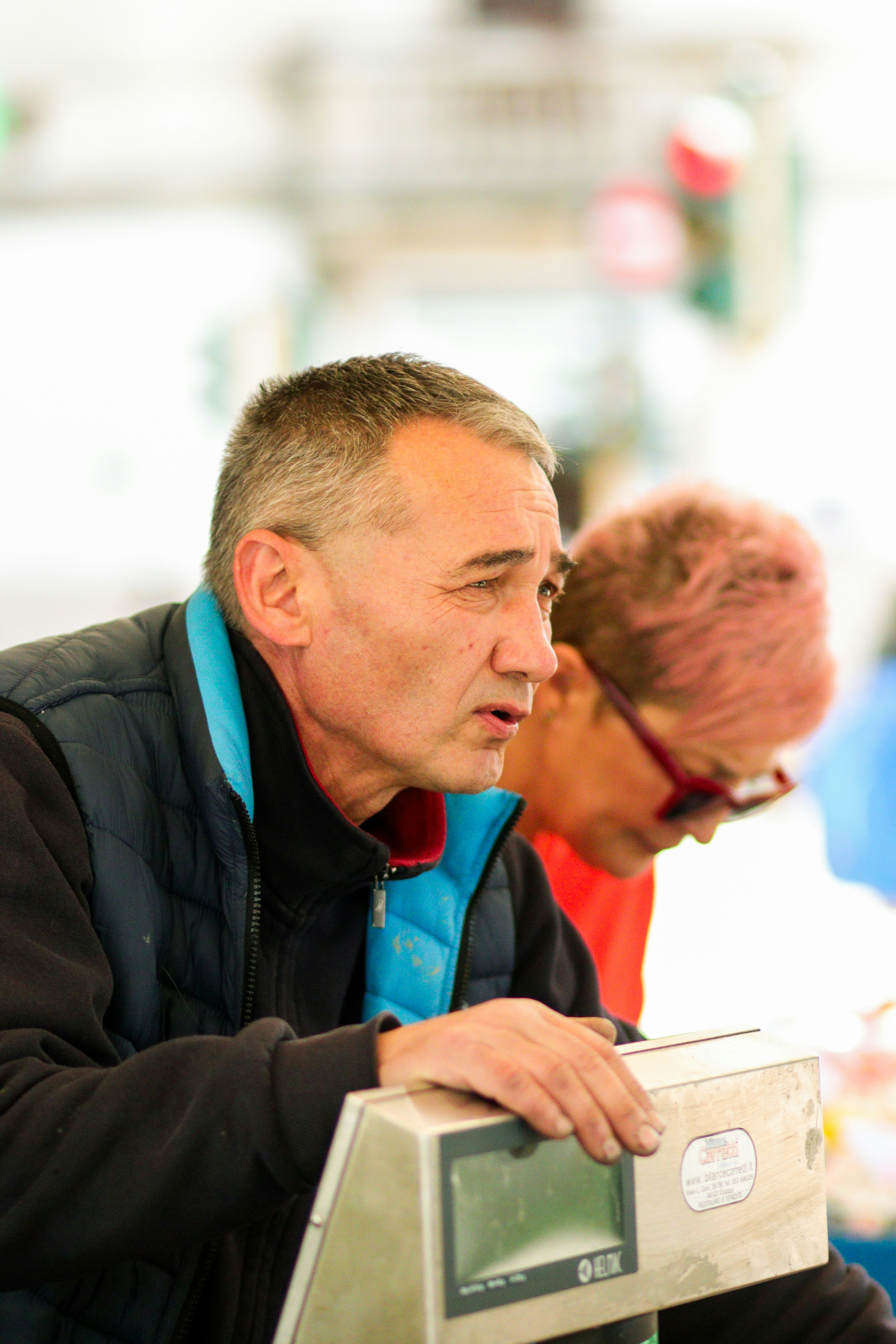 a man standing next to a woman on top of a scale