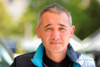 a man wearing a blue jacket and a black shirt