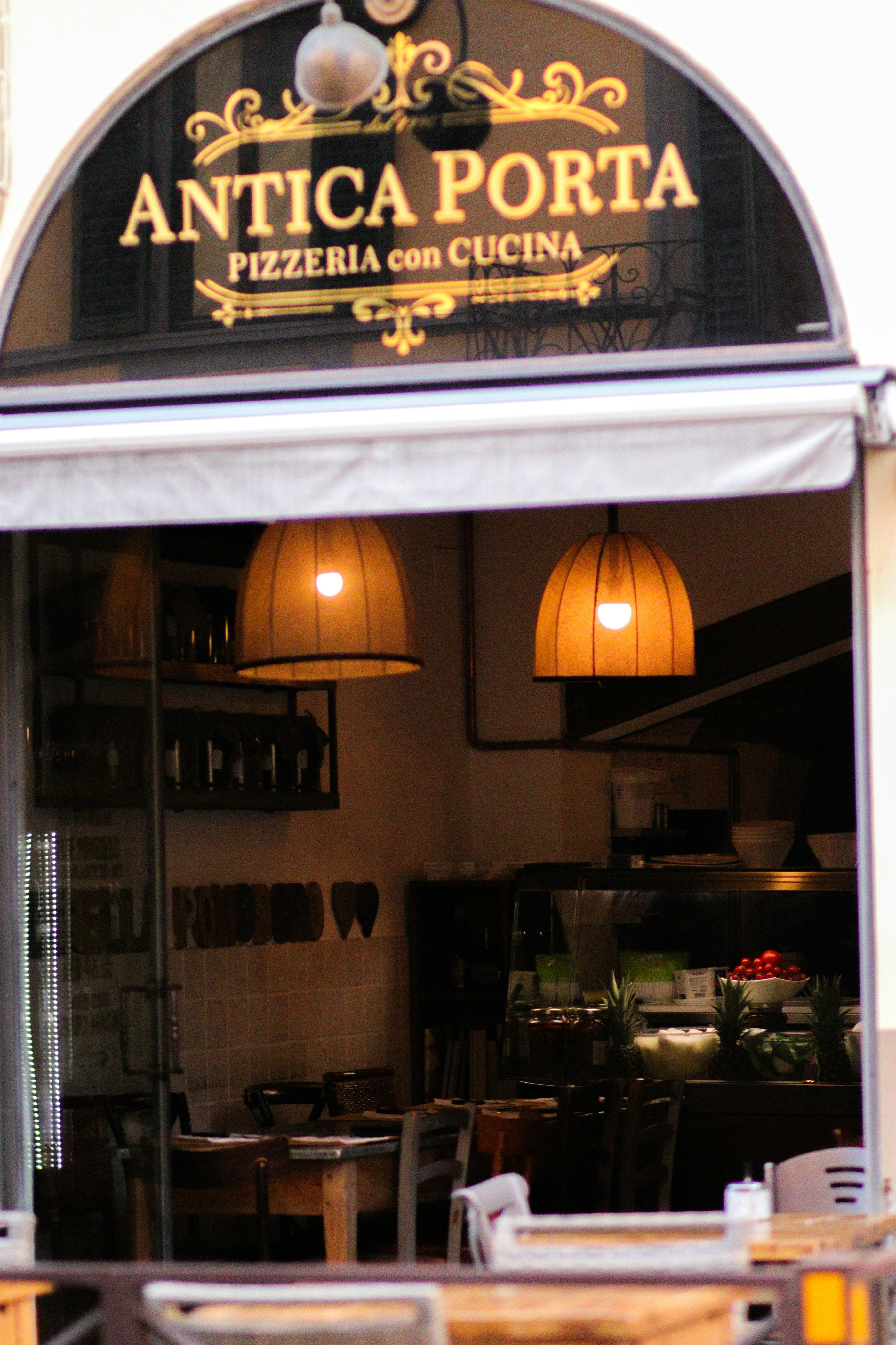 a restaurant with tables and chairs in front of it