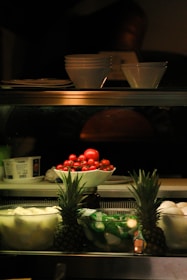 a display case filled with fruits and vegetables