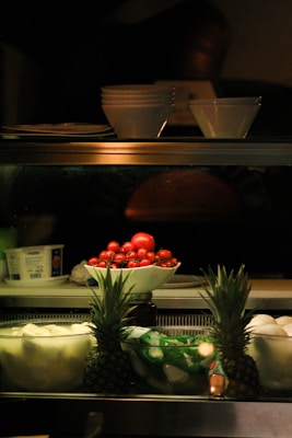 a display case filled with fruits and vegetables