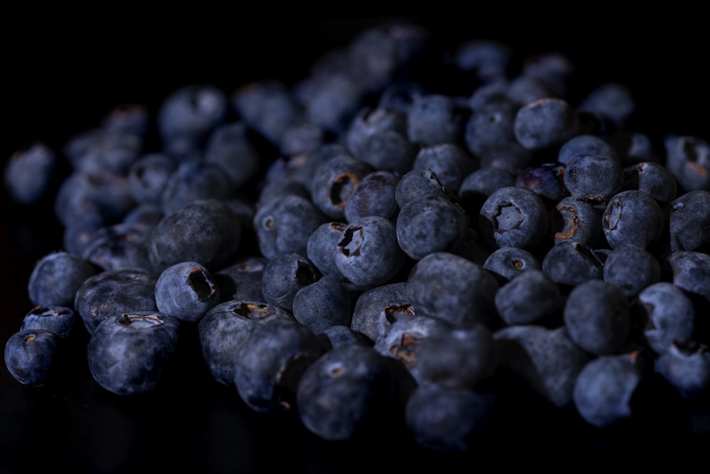 a pile of blueberries sitting on top of a table