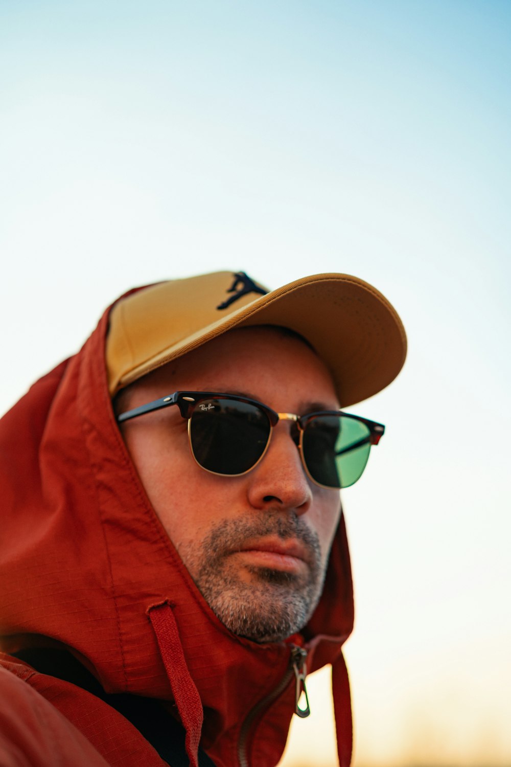a man wearing sunglasses and a red jacket
