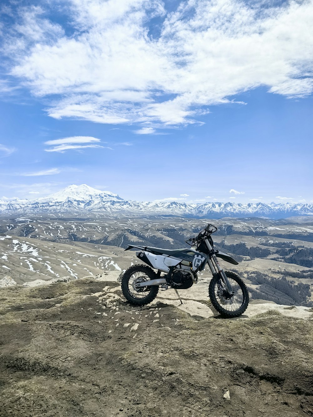 a motorcycle parked on top of a mountain