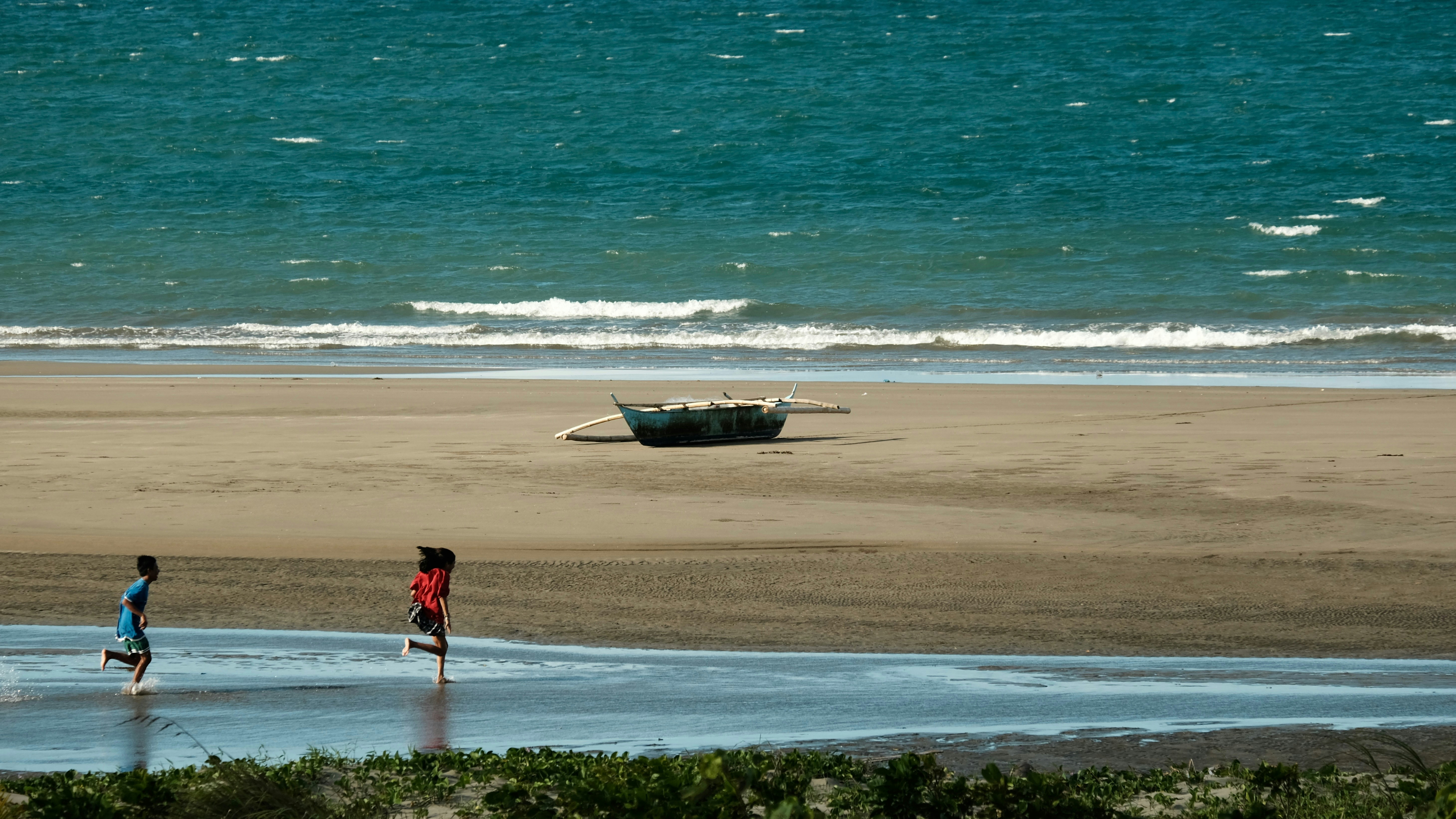a couple of people that are standing in the sand
