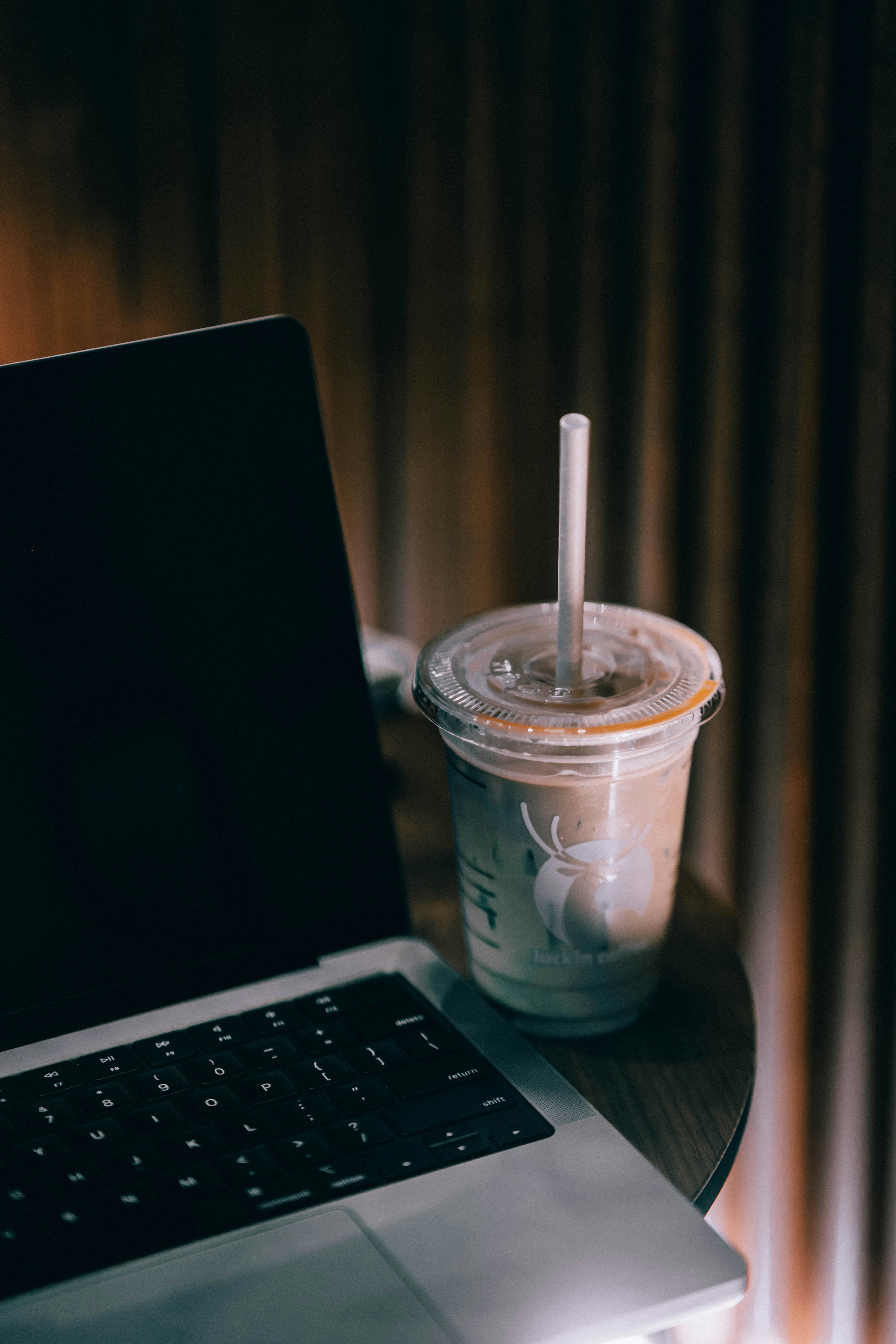 a laptop computer sitting on top of a wooden table