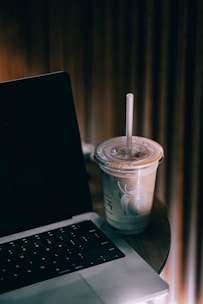 a laptop computer sitting on top of a wooden table