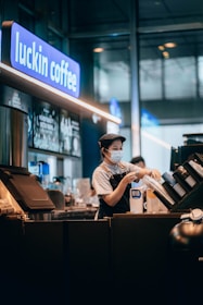 a woman wearing a face mask at a coffee shop