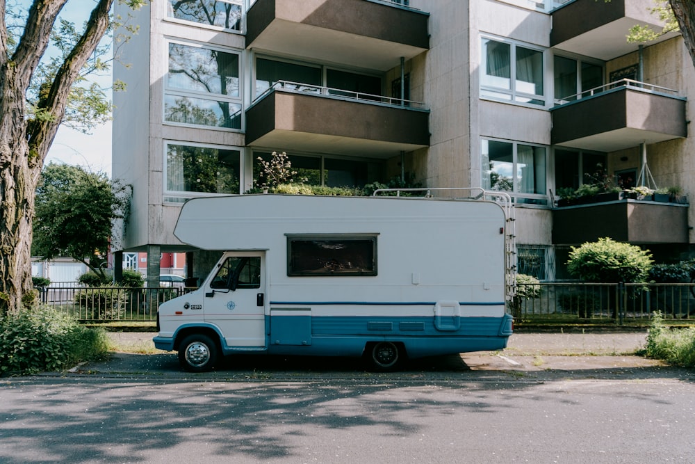 a blue and white truck parked in front of a building