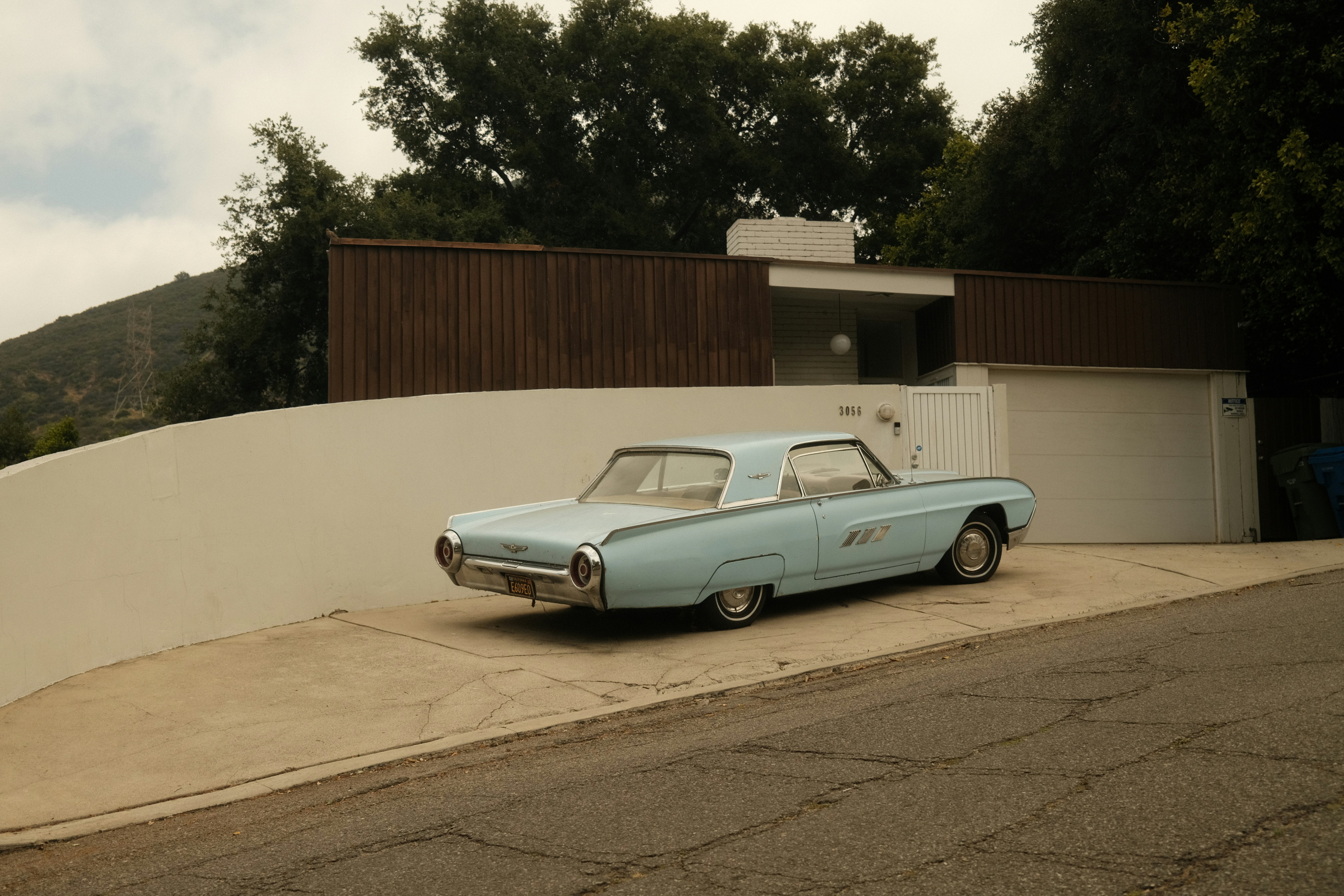 a blue car parked on the side of a road