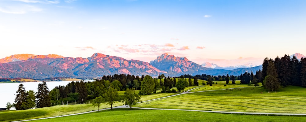 a scenic view of a mountain range with a lake in the foreground