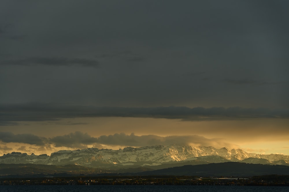 a large body of water under a cloudy sky