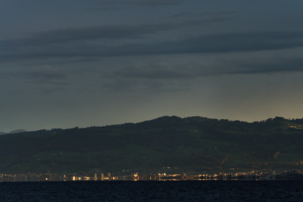 a large body of water with a city in the background