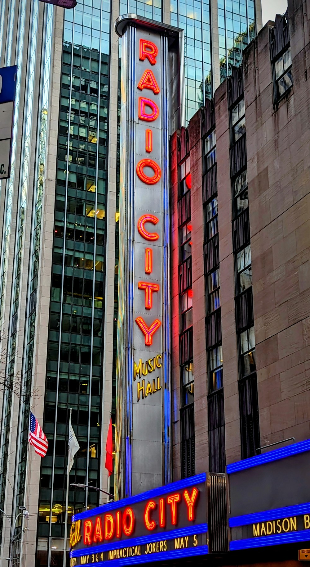 the radio city sign is lit up in red, white, and blue