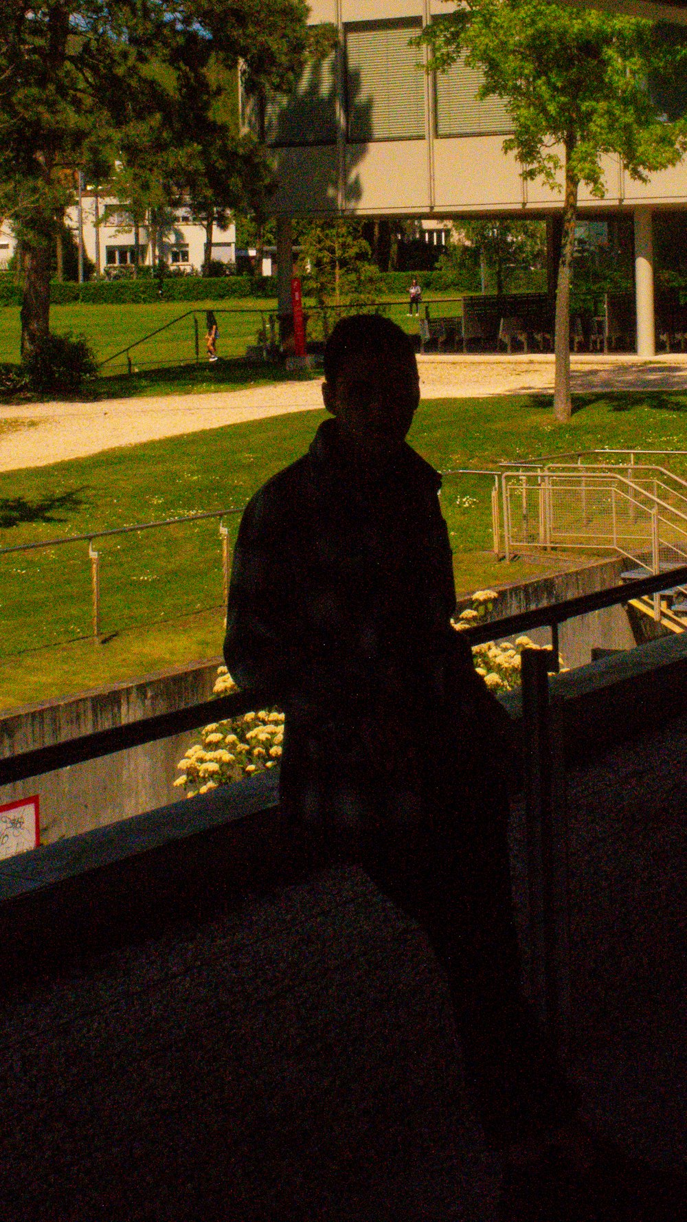 a man standing in front of a large building