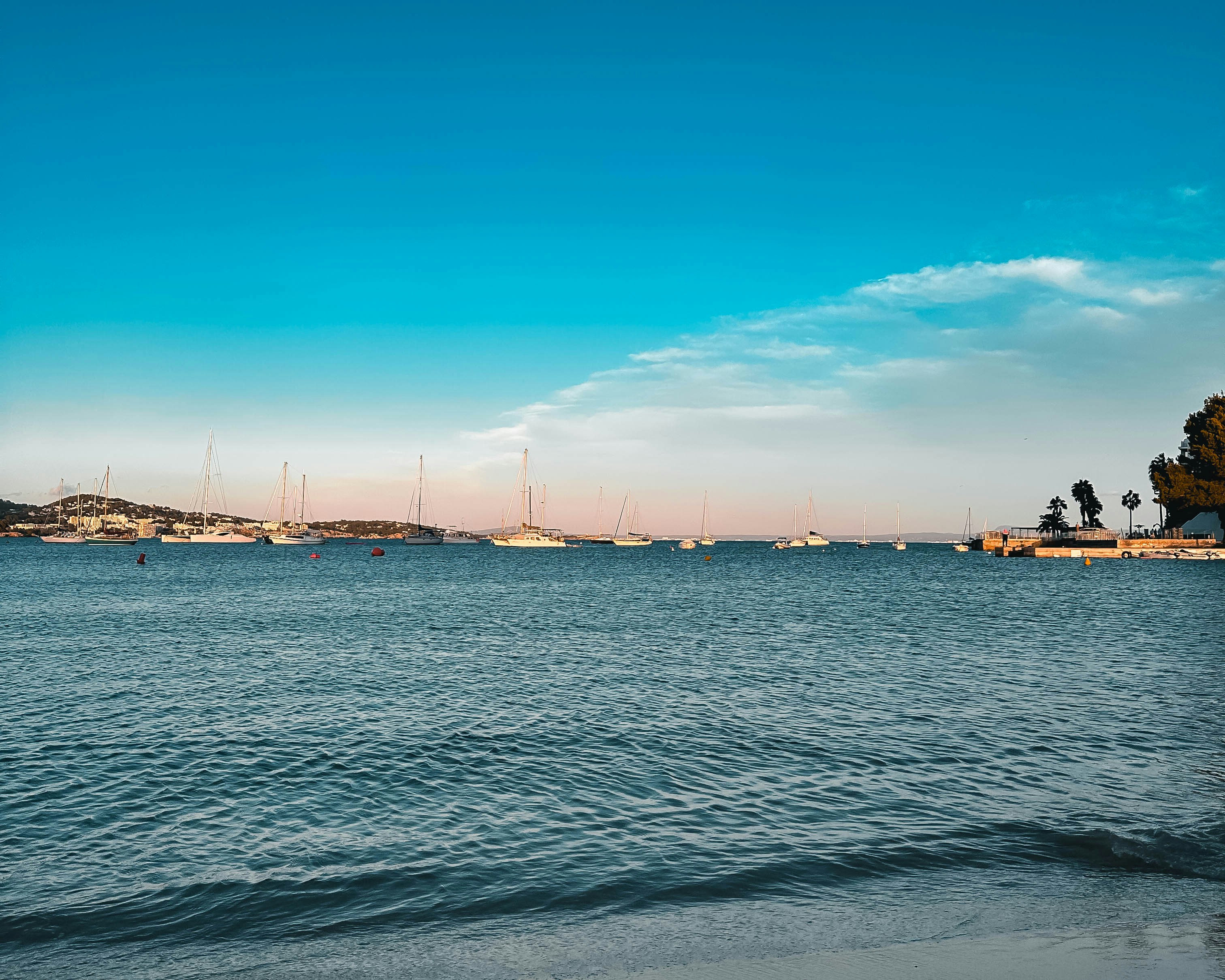 a body of water with boats in the distance
