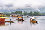 a group of boats floating on top of a lake